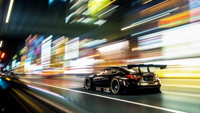 Black Lexus RC F racing through a city at night