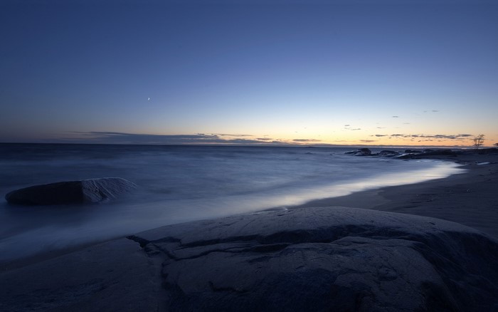 Long exposure beach at sunset with moon