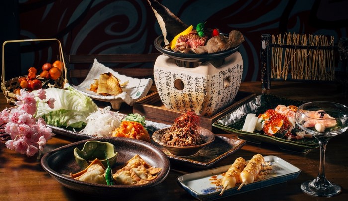 Japanese food spread with meat, sushi, and vegetables