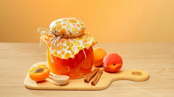 Jar of apricot jam with apricots and cinnamon