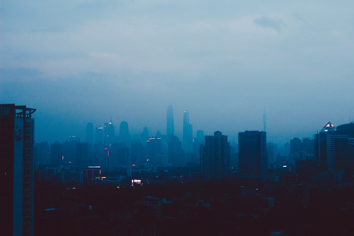 Dark cityscape with skyscrapers at dusk