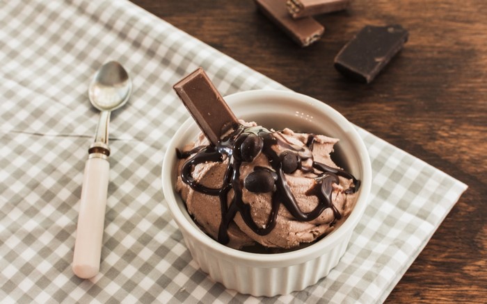 Chocolate ice cream with chocolate bar and sauce