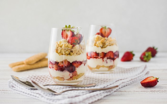 Strawberry trifle desserts in glasses with ladyfingers