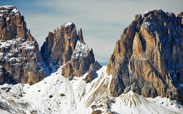 Snow-covered jagged mountain peaks under a clear sky