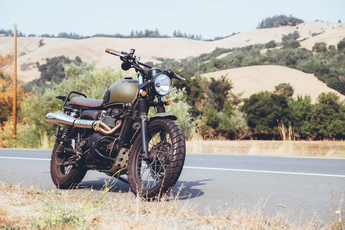 4K motorcycle on a road with hills