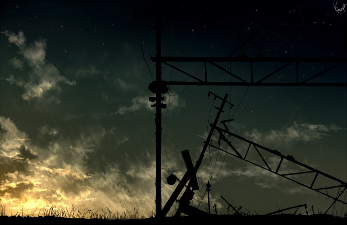 Silhouette of broken power lines against a sunset sky