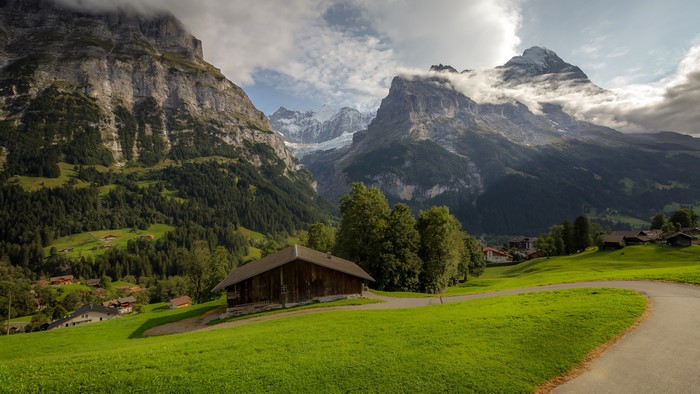 4K landscape of Alps mountains with a wooden house