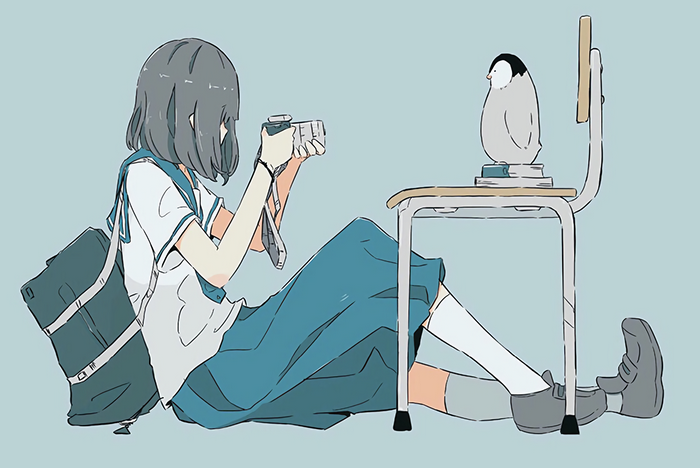 Girl in school uniform taking a picture of a penguin
