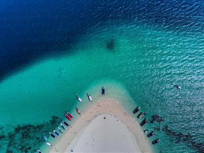 Aerial view of boats near a sandy beach in Thailand