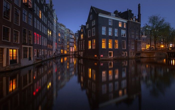 Amsterdam canal houses at night by Aleksandr Kurennoi