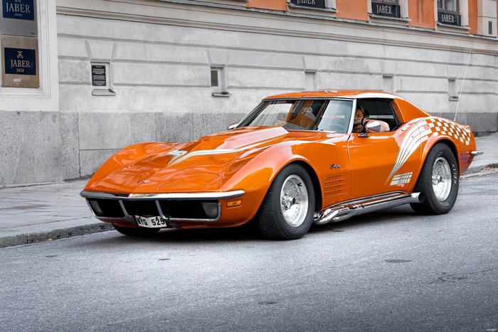 Orange Chevrolet Corvette with racing stripes