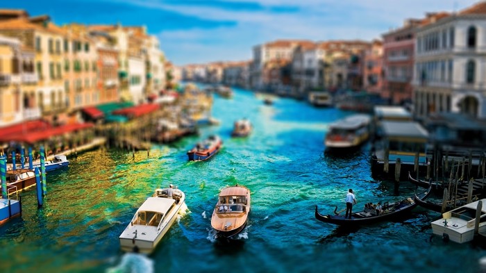 Venice canal with boats and gondolas, tilt-shift photography