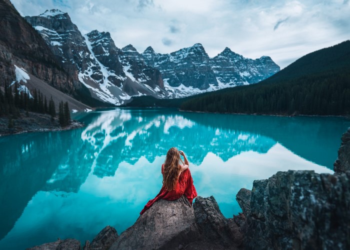Woman in red dress at Moraine Lake, Canada