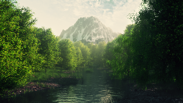 River flowing through a forest towards a snow-capped mountain