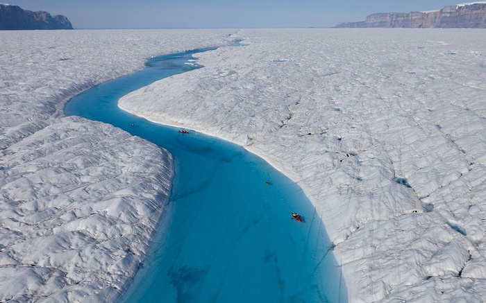 Kayakers on a glacial river in Greenland
