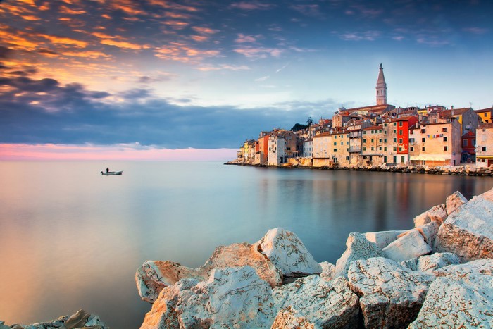 Rovinj, Croatia at sunset with a lone boat