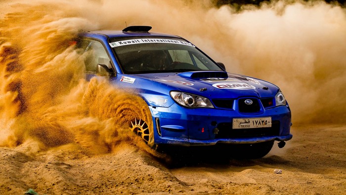 Blue Subaru Impreza WRX STi rally car drifting in desert