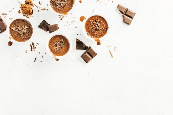 Hot chocolate in cups with chocolate shavings and bars