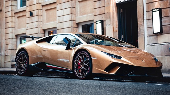 Gold Lamborghini Huracan Performante parked on city street