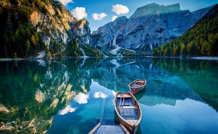 Boats on a clear mountain lake with reflections