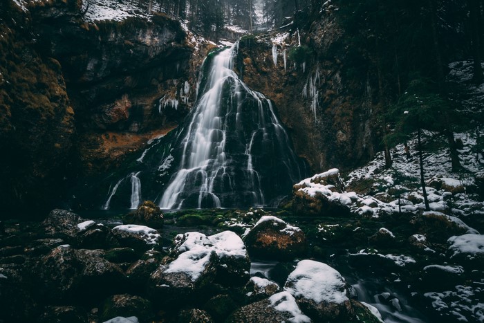 Dark Winter Waterfall in Forest with Snow