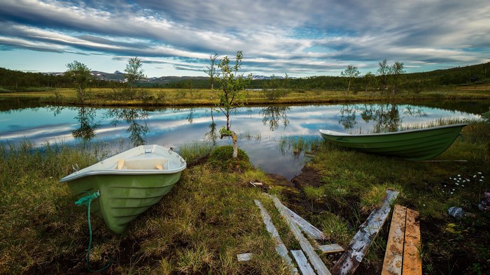 Boats on a lake with reflections