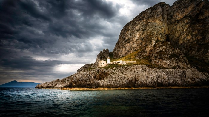 Lighthouse on a rocky cliff by the sea