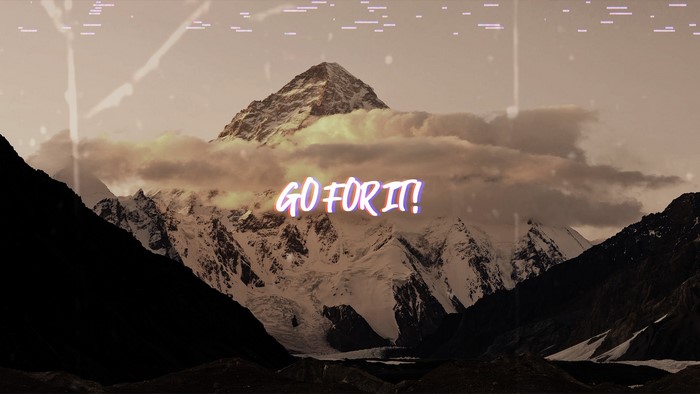 Motivational quote "GO FOR IT!" over snowy mountains
