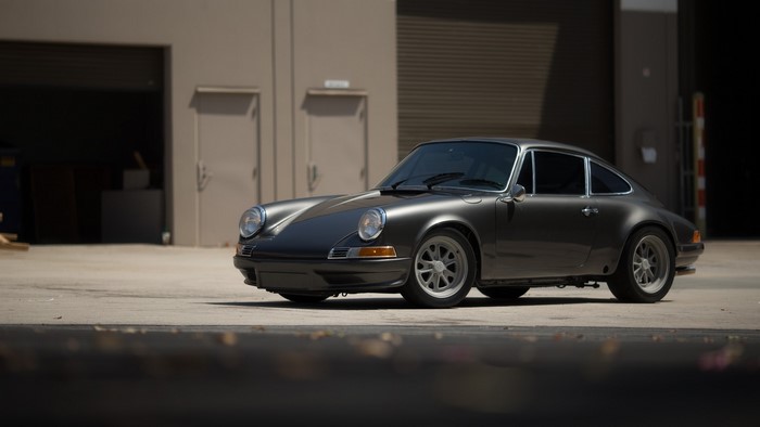 Dark gray Porsche 911 parked outside a building
