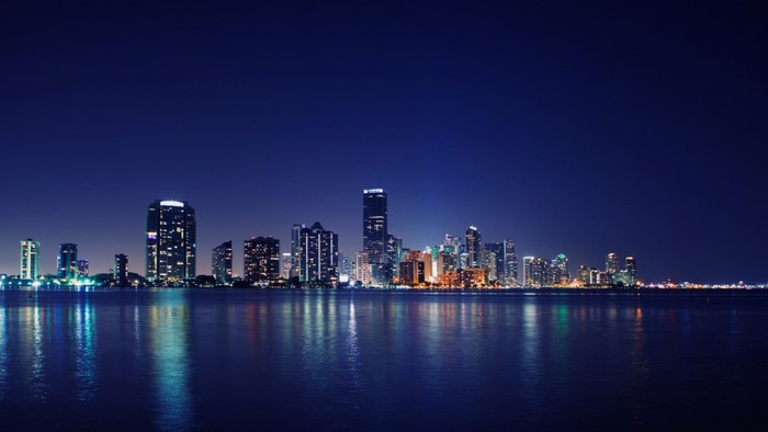 Miami skyline at night over the water