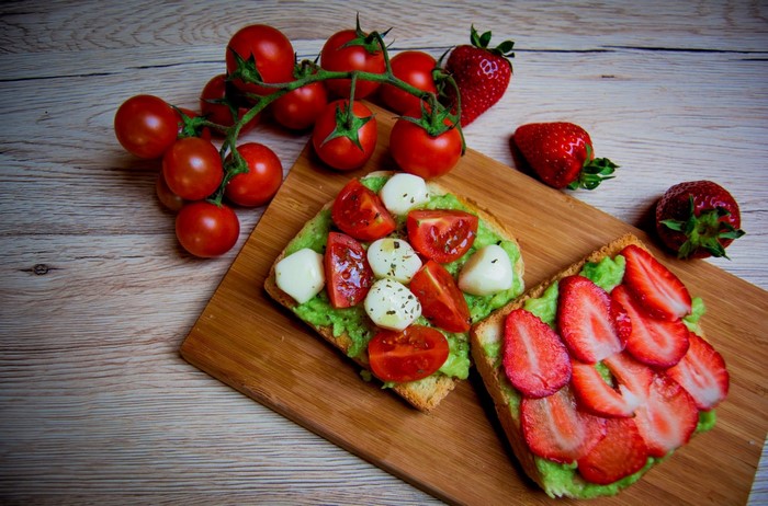 Avocado toast with tomatoes, mozzarella, and strawberries