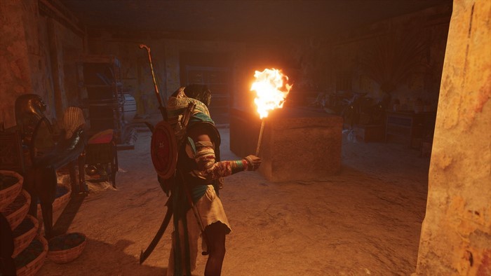 Bayek from Assassin's Creed Origins holding a torch