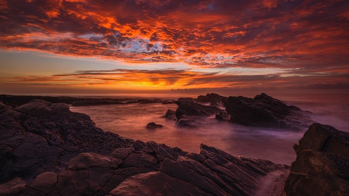 4K Sunset Over Rocky Coastline