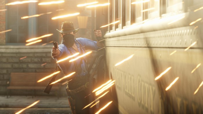 Man in hat and bandana firing gun near train
