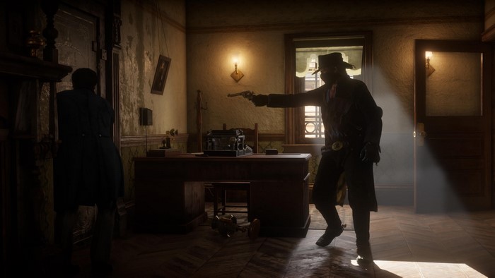 Man in cowboy hat pointing a gun in an office