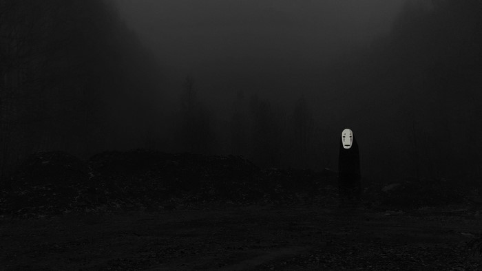 No-Face from Spirited Away in a dark, foggy landscape
