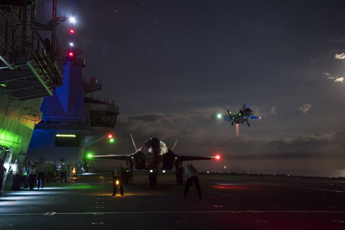 F-35B Lightning II aircraft on an aircraft carrier at night