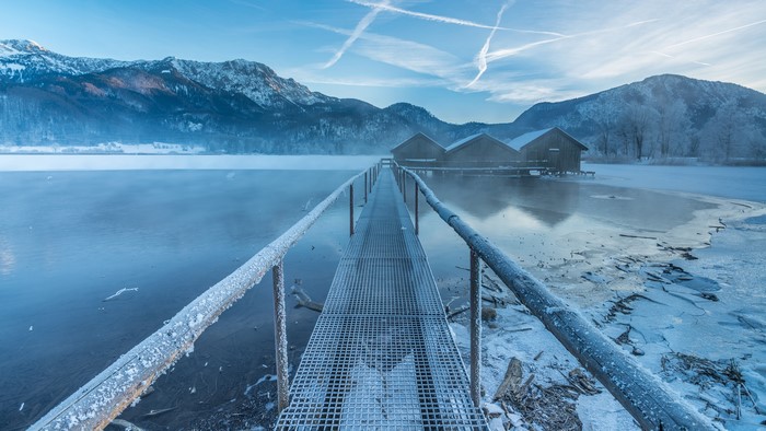 Winter lake with boathouses and mountains in Germany