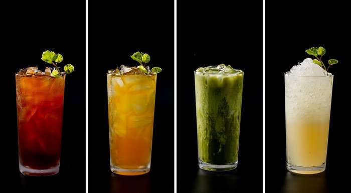 Four iced drinks in tall glasses