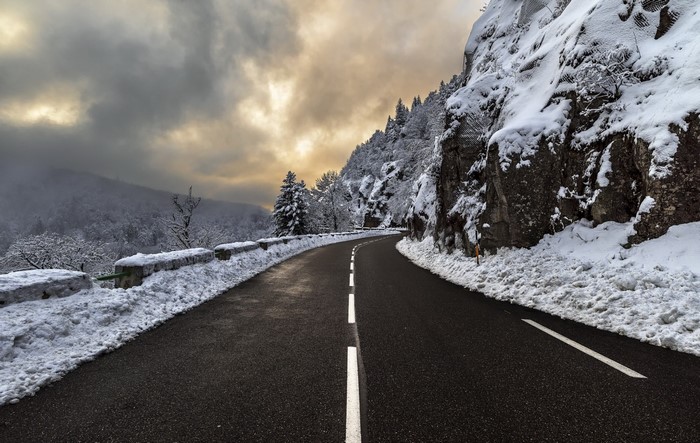 Winding mountain road in winter with snow