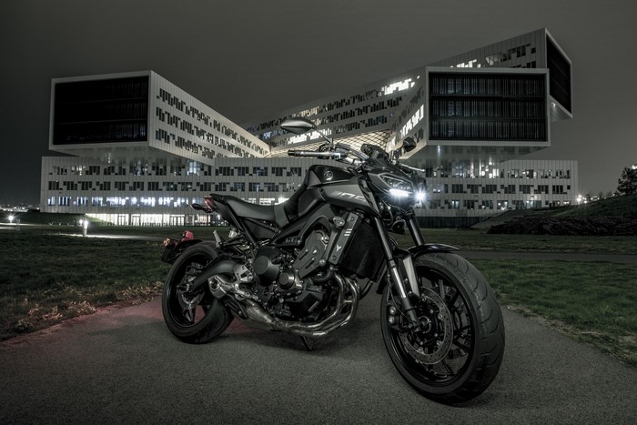 Yamaha motorcycle parked in front of a modern building at night