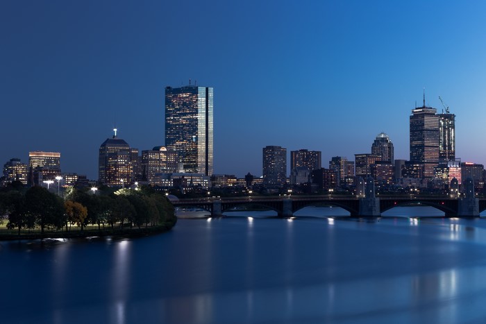 Boston skyline at dusk with bridge and river