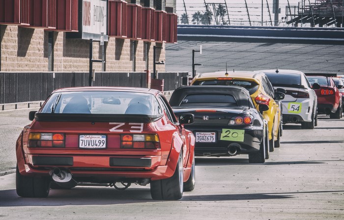Porsche 944, Honda S2000, and other cars at a race track