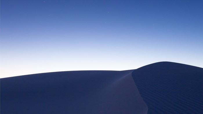Desert dunes under a twilight sky
