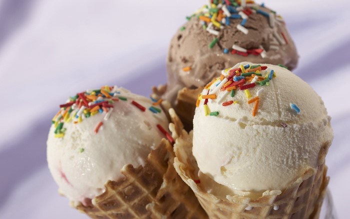 Three ice cream cones with sprinkles