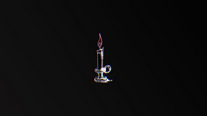 Candle in a candlestick on a black background