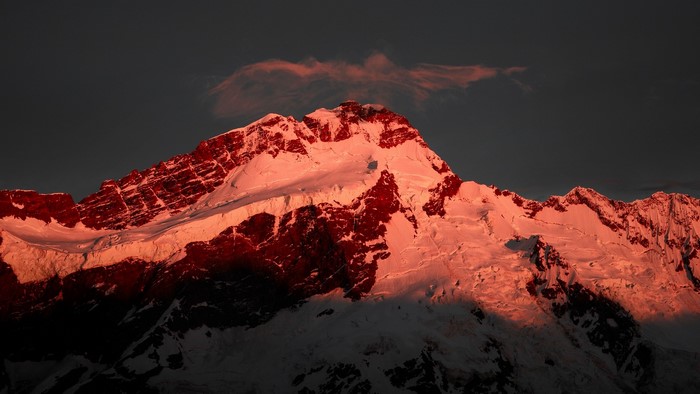 Snowy mountain peak illuminated by sunset in New Zealand