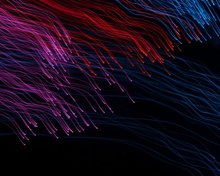 Abstract light trails in pink, red, and blue