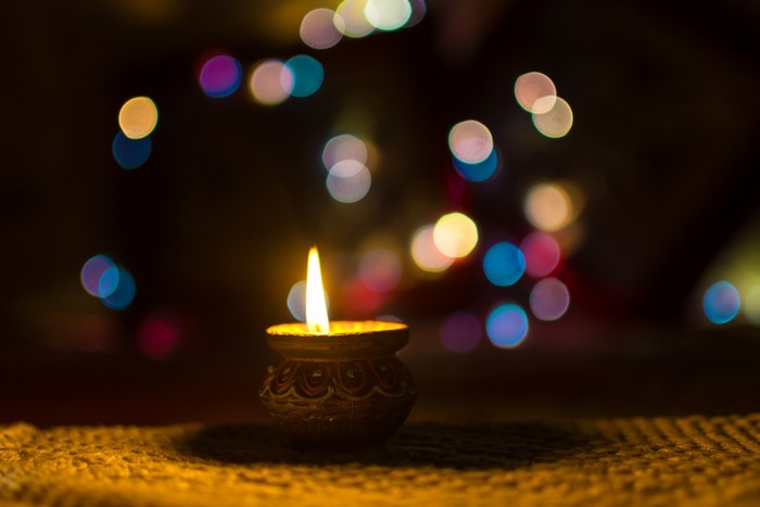 Diwali lamp with blurred colorful lights