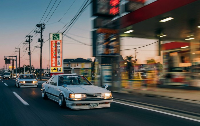 Toyota Chaser cars driving on a road at sunset